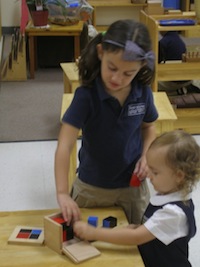 Two primary students working with the Binomial Cube.